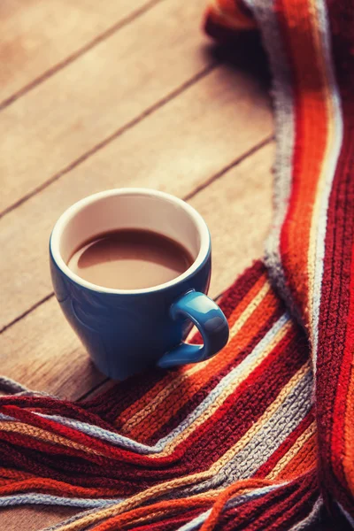 Blue cup of the coffee and vintage scarf. — Stock Photo, Image