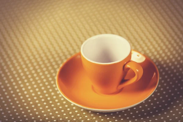 Cup of a coffe on polka dot cover. — Stock Photo, Image