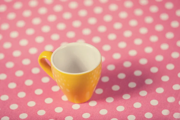 Cup of a coffe on polka dot cover — Stock Photo, Image