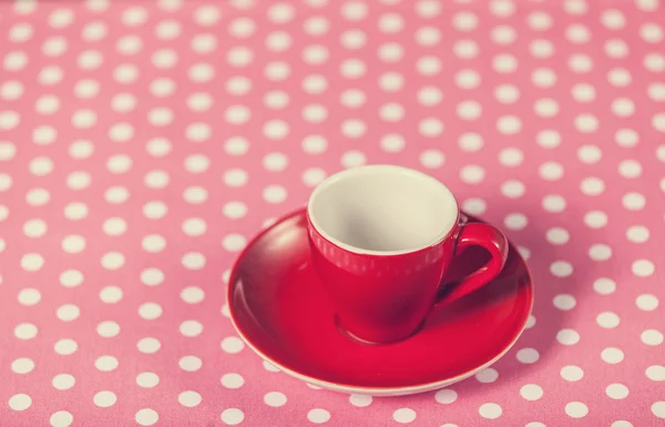 Cup of a coffee on polka dot cover. — Stock Photo, Image