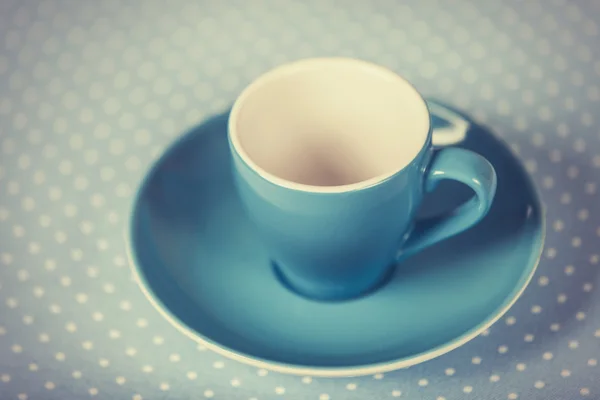 Coppa di un caffè su copertura di punto a pois — Foto Stock