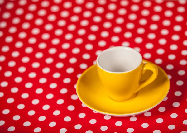 Cup of a coffe on polka dot cover — Stock Photo, Image