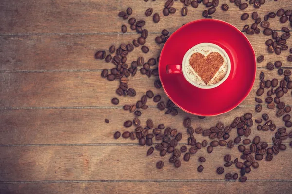 Kaffeetasse mit Herzform auf einem Holztisch. — Stockfoto