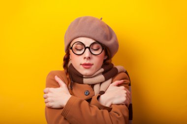 Kızıl saçlı kız ceket ve Sarı zemin üzerine eşarp.