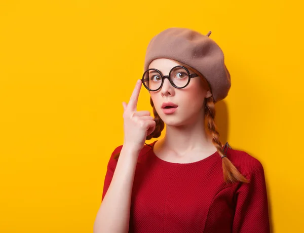 Redhead girl with pigtails on yellow background. — Stock Photo, Image