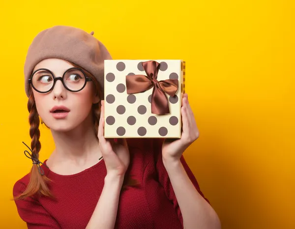 Redhead girl with suitcase on yellow background. — Stock Photo, Image