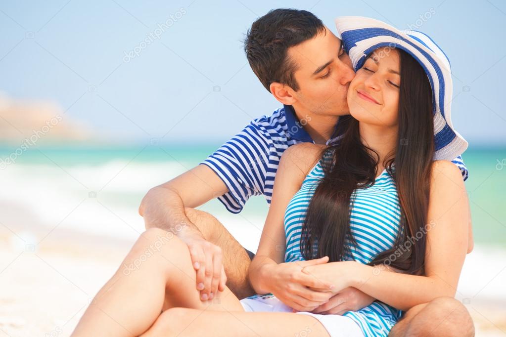 Beautiful couple kissing on the beach.