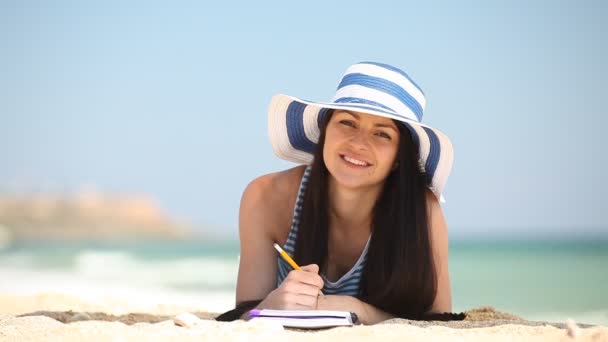 Young brunette girl on the beach in summer time. — Stock Video