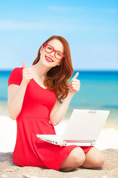 Redhead girl in the glasses with notebook on the beach — Stock Photo, Image