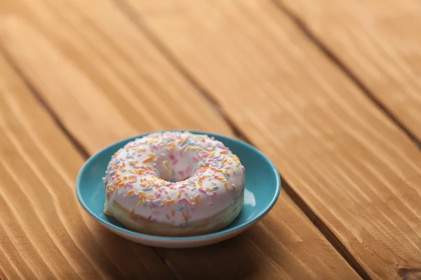 Donut on wooden table. — Stock Photo, Image