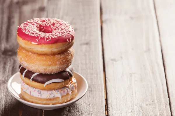 Donuts on woodent table. — Stock Photo, Image