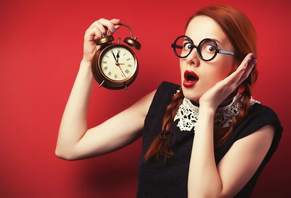 Surprised redhead girl with clock. — Stock Photo, Image