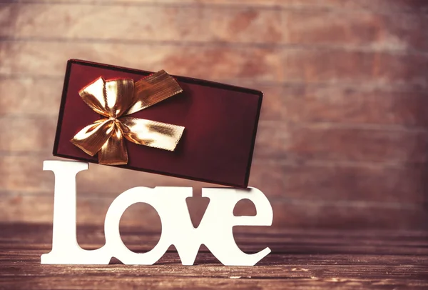 Doos van de gift en word liefde op een tafel. — Stockfoto