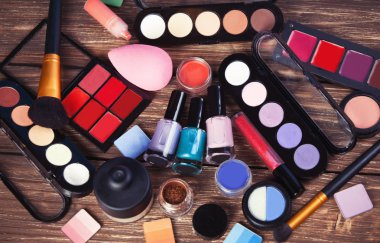 Cosmetics on wooden table. clipart