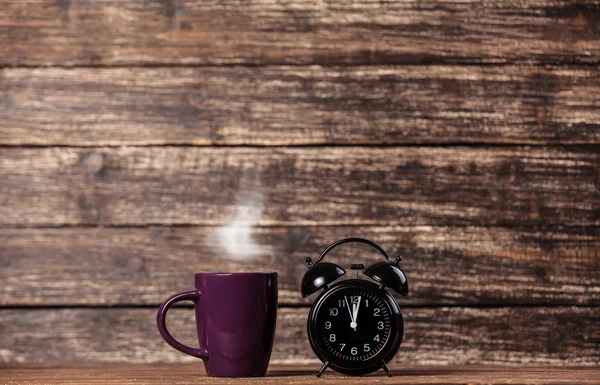 Tea or coffee cup and alarm clock — Stock Photo, Image