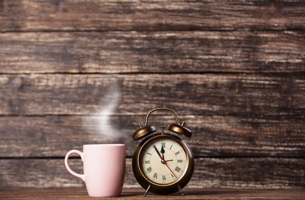 Tea or coffee cup and alarm clock — Stock Photo, Image