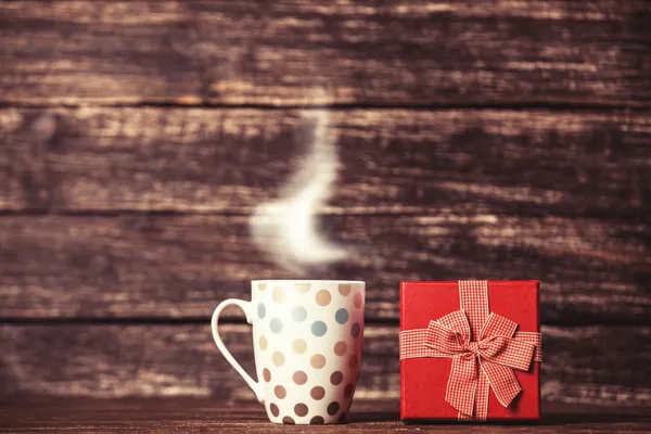 Gift box and cup of coffee — Stock Photo, Image