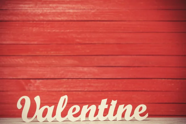 Wooden word Valentine on red background. — Stock Photo, Image