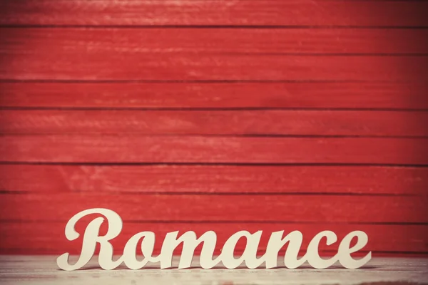 Wooden word Romance on red background. — Stock Photo, Image