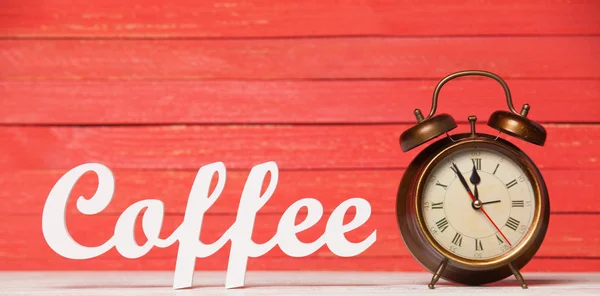 Alarm clock and wooden word Coffee. — Stock Photo, Image