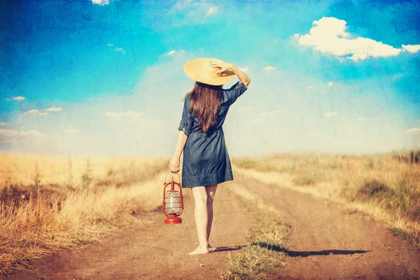 Girl with lamp on country side road. — Stock Photo, Image