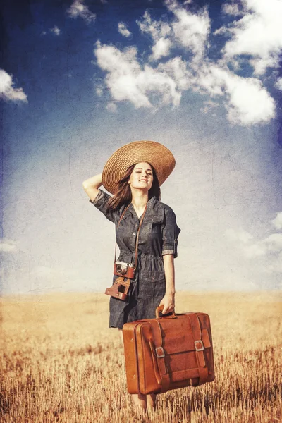 Brunette girl with suitcase on countryside. — Stock Photo, Image