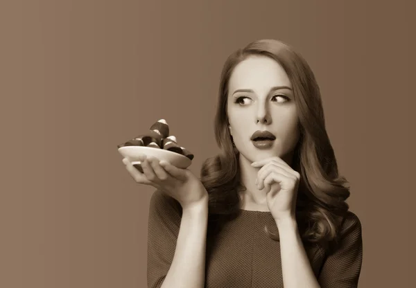 Women with candy. Photo in sepia color image style. — Stock Photo, Image
