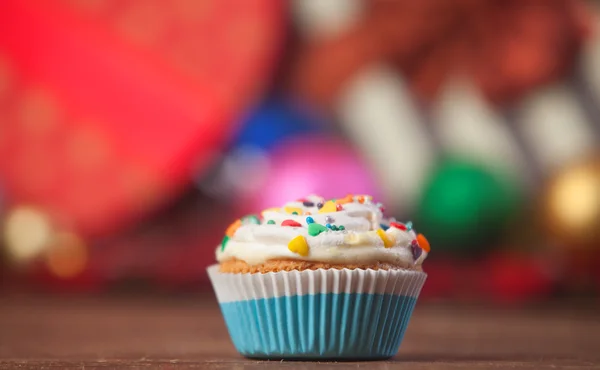 Christmas cupcake and gifts on background. — Stock Photo, Image