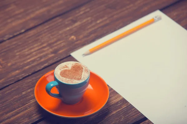 Cup of coffee and pencil with paper. — Stock Photo, Image