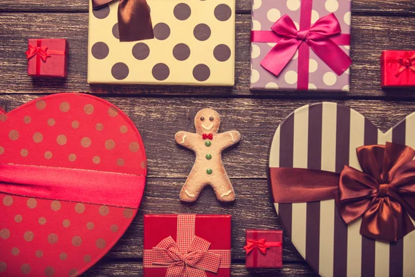 Cookie man and christmas gifts around — Stock Photo, Image