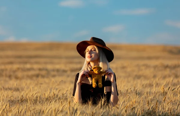 Blonde Woman Black Dress Hat Scarf Holds Teddy Bear Toy — Stock Photo, Image