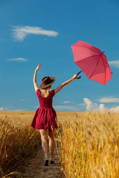 Buğday Tarlasında Şemsiyeli Şapkalı Kırmızı Elbiseli Sarışın Kız — Stok fotoğraf