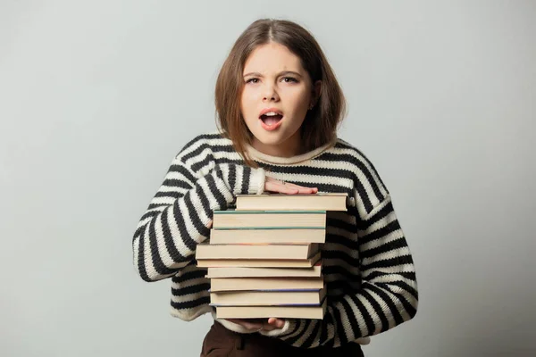 Sad Beautiful Girl Striped Sweater Books White Background — стоковое фото