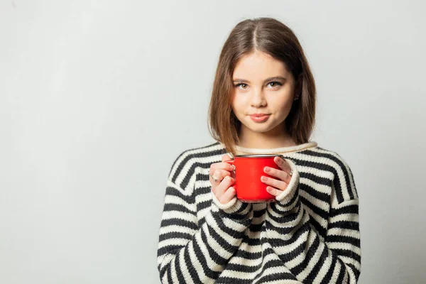 Beautiful Girl Striped Sweater Red Mug White Background — Stockfoto