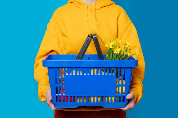 Stylish Female Yellow Hoodie Blue Basket Flowers Blue Background — Stock Photo, Image