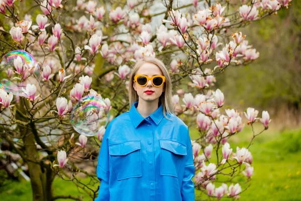 Stylish Woman Glasses Blue Shirt Soap Bubbles Magnolia Tree Spring — Zdjęcie stockowe