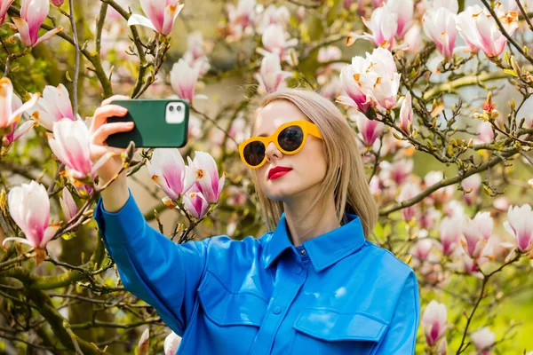 Stylish Woman Glasses Blue Shirt Magnolia Tree Make Selfie Mobile — стоковое фото