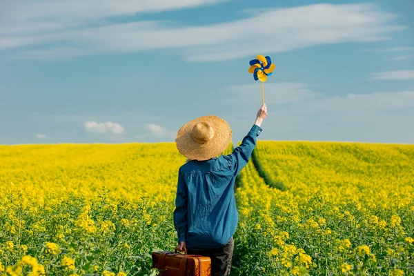 Woman Hat Suitcase Pinwheel Rapeseed Field — 스톡 사진