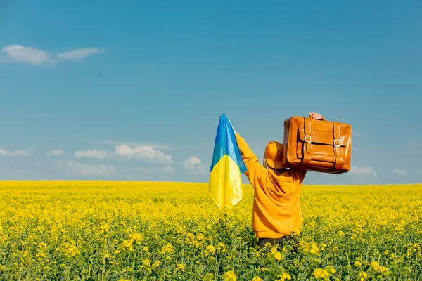 Woman Yellow Hoodie Ukrainian Flag Suitcase Rapeseed Field — стокове фото