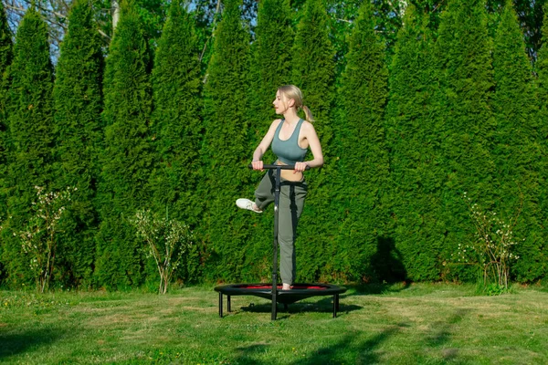 Girl Does Jumping Fitness Trampoline Outdoor Green Grass Trees Background — Stok fotoğraf