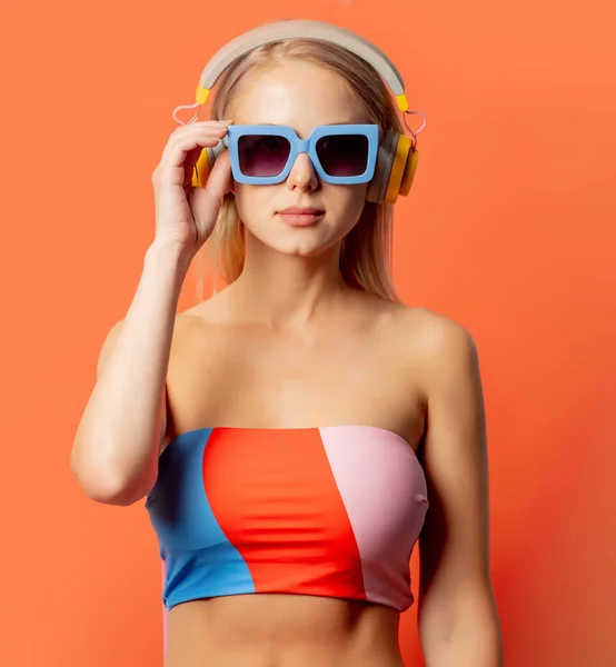 Stylish Blond Woman Colored Swimming Suit Headphones Sunglasses Orange Background — Stock Photo, Image