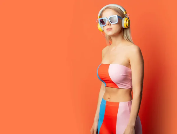 Stylish Blond Woman Colored Swimming Suit Headphones Sunglasses Orange Background — 图库照片