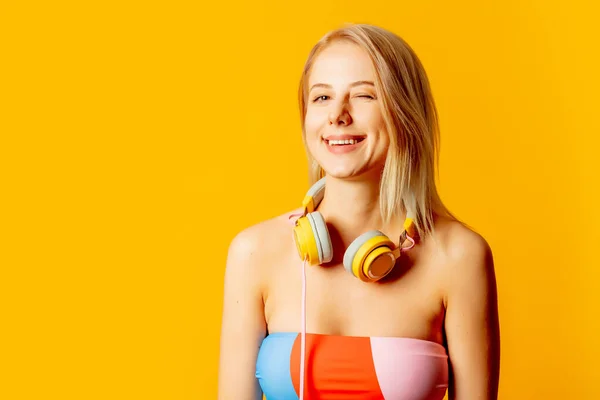Stylish Blond Woman Colored Swimming Suit Headphones Yellow Background —  Fotos de Stock