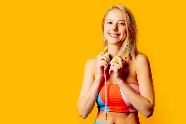 Stylish Blond Woman Colored Swimming Suit Headphones Yellow Background — Stock fotografie