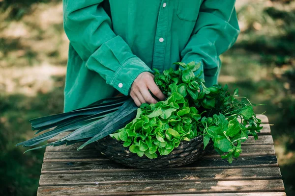 Stylish Woman Green Shirt Sort Vegetables Basket Wooden Table Outdoor — Fotografia de Stock
