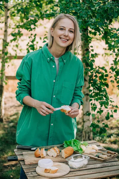 Stylish Woman Green Shirt Make Snack Bread Cheese Table Outdoor — Foto Stock