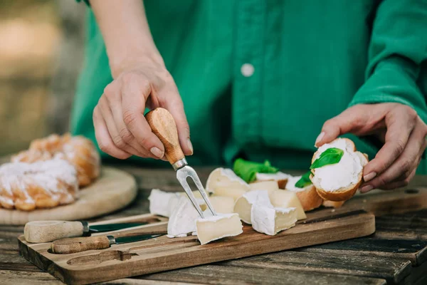 Stylish Woman Green Shirt Stabs Cheese Snack Fork — Zdjęcie stockowe