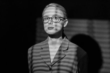 portrait of woman in noir style with shadow from blinds