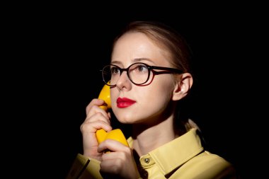 Stylish woman with handset and light focus