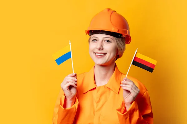 Woman Construction Worker Helmet Orange Overalls Two Ukrainian German Flags — Stock Photo, Image